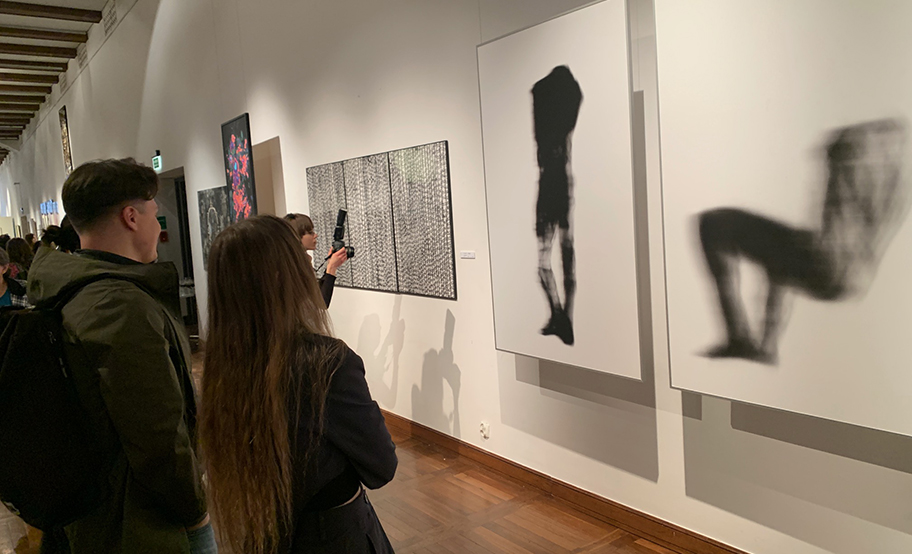 Osoby oglądające prace na wystawie WG